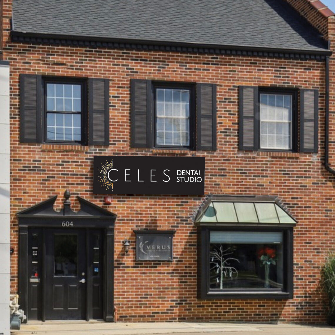 Exterior view of Celes Dental Studio, a brick building with black shutters and awning, located at 604 in Western Springs, IL